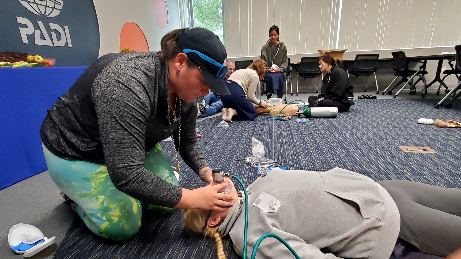 Mermaid instructor leading Emergency First Response CPR and first aid training during an in-person class